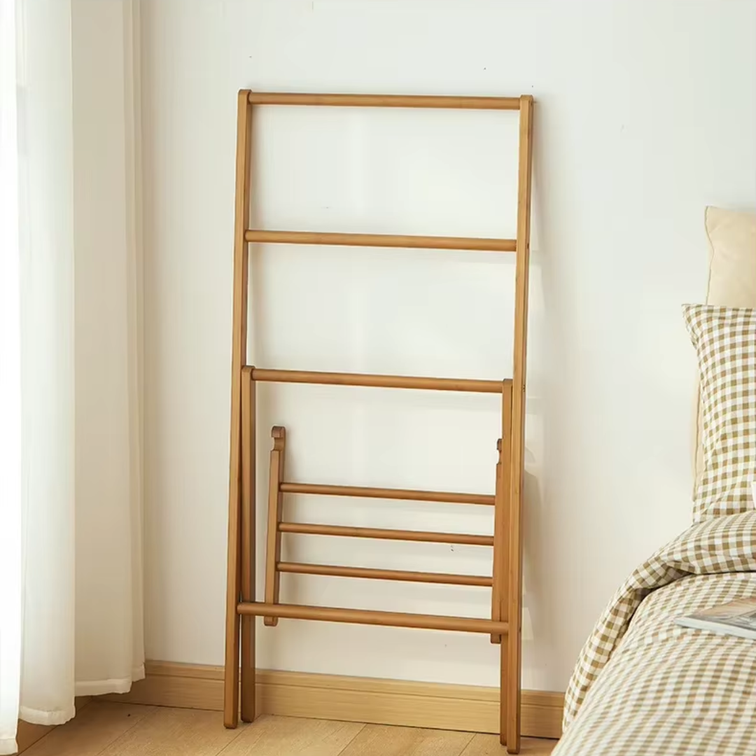 Bamboo Wooden Clothing Rail against  a wall showcasing foldable feature