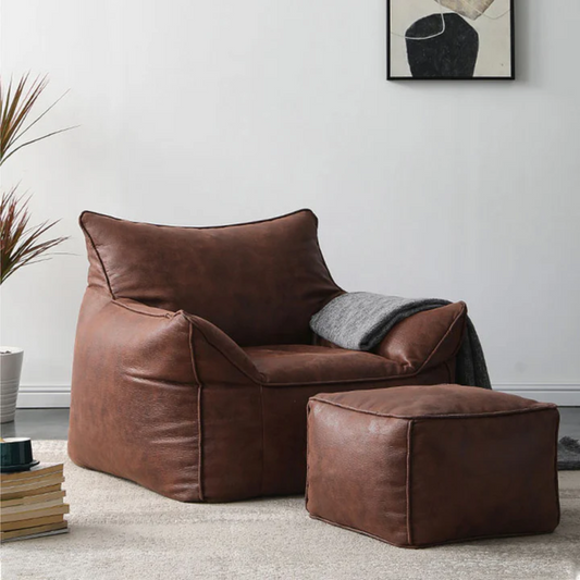 Brown Leather Bean Bag Armchair styled in a living room with matching foot rest