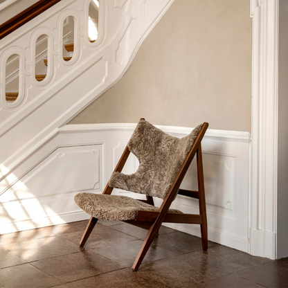 Faux Sheepskin Knitted Lounge Chair styled in a modern hallway