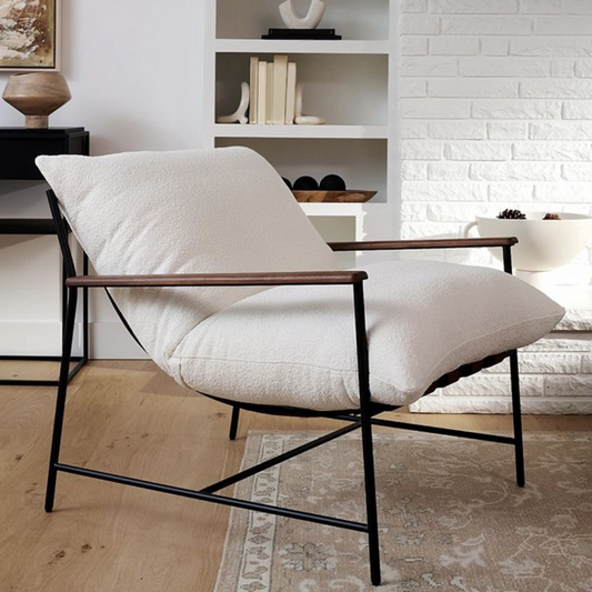 Industrial accent chair with upholstered seat and metal frame in a living room