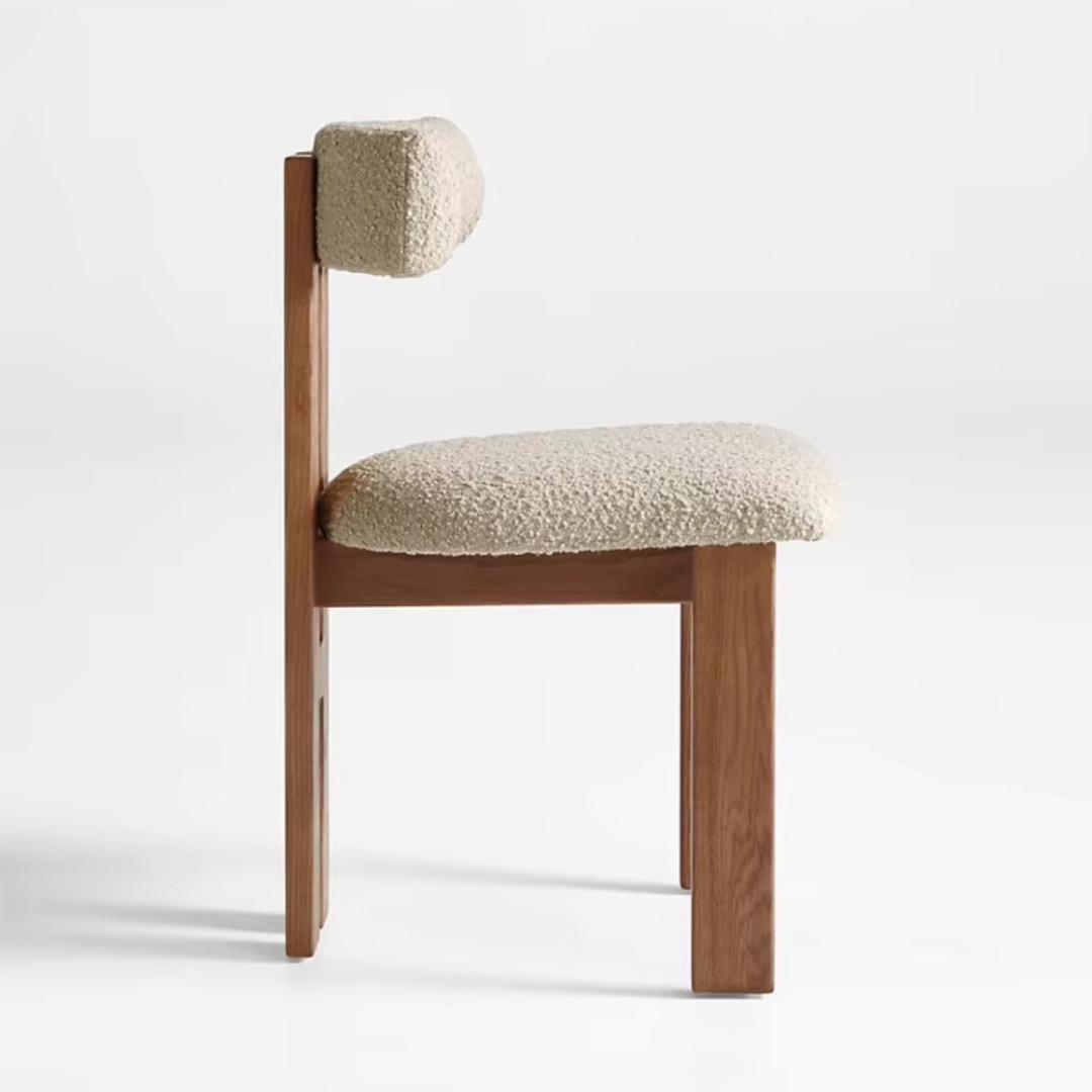 Side view of dining chair with white boucle upholstery