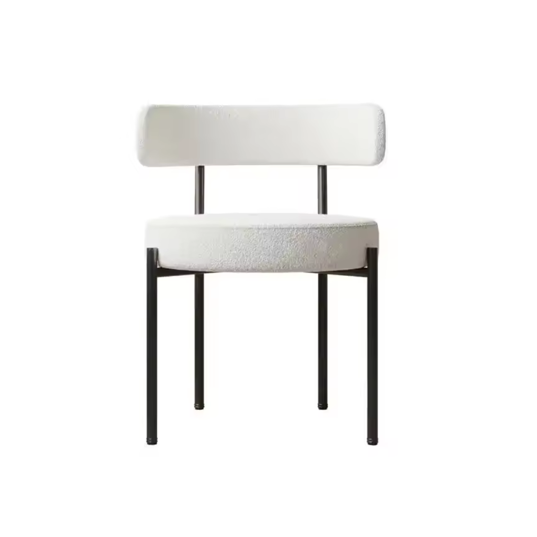 Angled view of white boucle metal frame dining chair