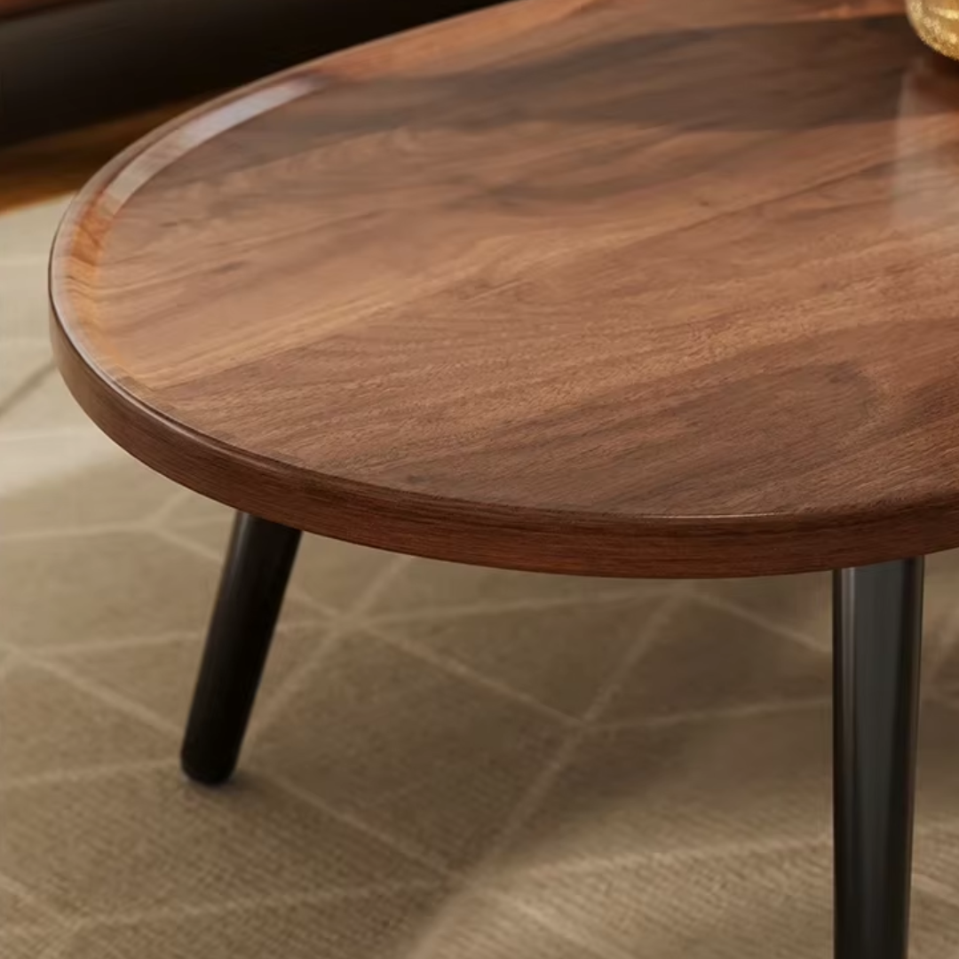 close up  view of oval wood coffee table with black frame