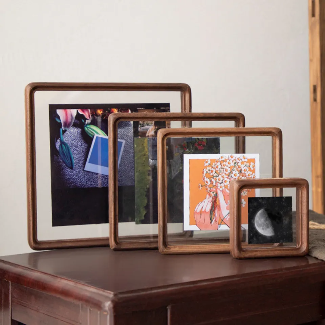 dark Walnut wooden picture frames all sizes stacked together on a sideboard