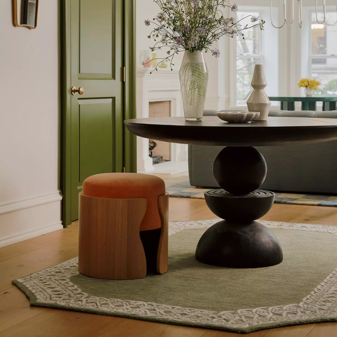 Round Black Pedestal Dining Table styled in a mid century dining room