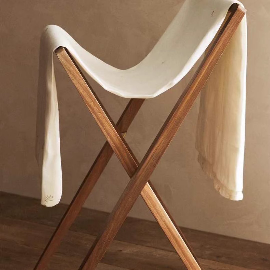 wooden free standing towel rail with a towel on it 