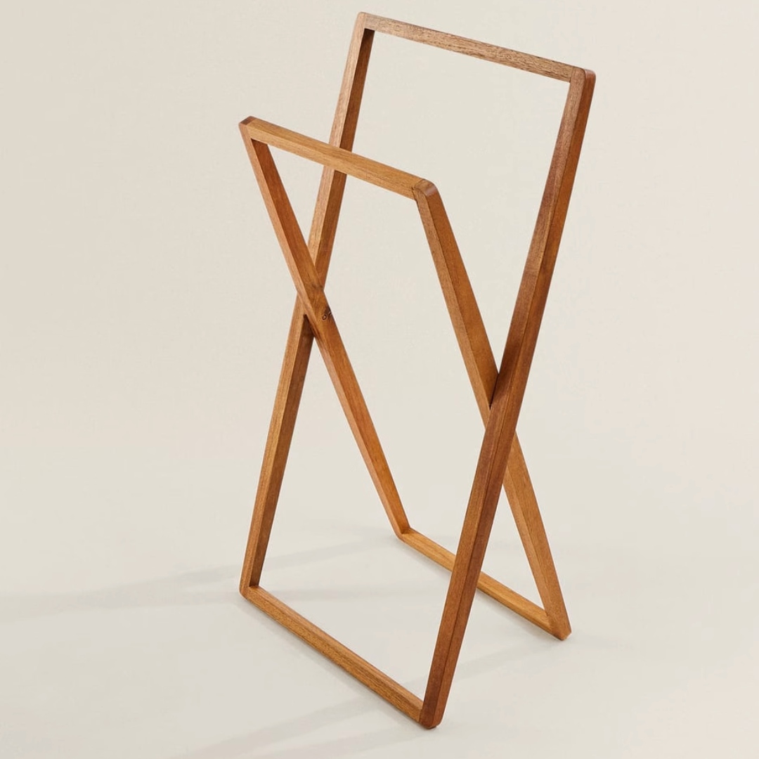 wooden free standing towel rail against a white background